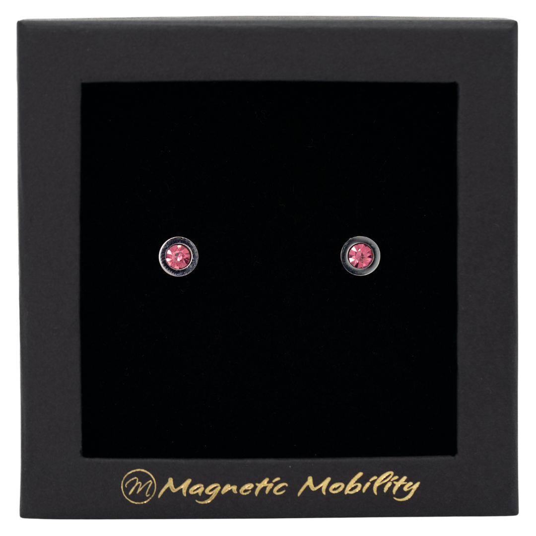 Magnetic Mobility October Birthstone Stud Earrings featuring pink tourmailne Swarovski crystals, elegantly presented in a black box with Magnetic Mobility branding. These magnetic back earrings offer stylish pain relief.
